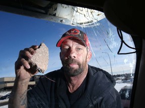Darren Malo holds a rock which struck his truck on Deerfoot Trail on Feb. 27, 2019. Malo said the rock was thrown from the 8th Avenue N.E. bridge.
