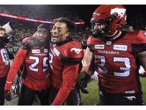 Calgary Stampeders defensive back Jamar Wall, defensive back Patrick Levels and linebacker Eric Mezzalira celebrate an interception against the Ottawa Redblacks during the second half of the 106th Grey Cup at Commonwealth Stadium in Edmonton on Nov. 25.