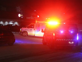 A Calgary EMS vehicle sits parked off 71 Avenue S.E. after a pedestrian was struck by a vehicle on Feb. 14, 2019. (Ryan Rumbolt / Postmedia)