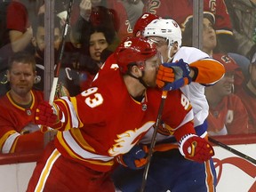 Calgary Flames Sam Bennett battles New York Islanders Ryan Pulock in third period action at the Scotiabank Saddledome in Calgary on Wednesday Feb. 20, 2019.