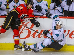 Sam Bennett levels Tomas Hertle during a game against the San Jose Sharks at the Saddledome on Dec. 31, 2018.