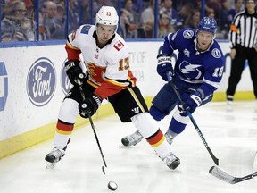 Calgary Flames Johnny Gaudreau carries the puck behind the Tampa Bay Lightning goal on Jan. 11, 2018, in Tampa, Fla. The Flames won that game 5-1.