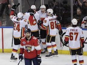 Calgary Flames center Mark Jankowski, center, celebrates with teammates after scoring agains the Florida Panthers during the third period of an NHL hockey game Thursday, Feb. 14, 2019, in Sunrise, Fla. (AP Photo/Brynn Anderson) ORG XMIT: FLBA124