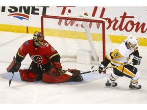 Calgary Flames goalie Mike Smith reacts after Pittsburgh Penguins Phil Kessel scores their sixth goal in second period action at the Scotiabank Saddledome in Calgary on Thursday October 25, 2018. Darren Makowichuk/Postmedia