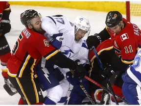 Calgary Flames Mark Giordano batlles with Tampa Bay Lightning Ryan McDonagh in third period action at the Scotiabank Saddledome in Calgary on Thursday December 20, 2018. Darren Makowichuk/Postmedia