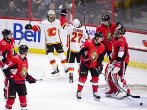 Calgary Flames centre Austin Czarnik (27) celebrates his game winning goal as he skates towards teammate Calgary Flames right wing Michael Frolik (67) against the Ottawa Senators during the third period NHL hockey action in Ottawa on Sunday, Feb. 24, 2019.