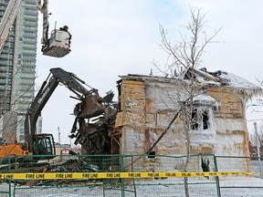 Calgary fire department investigators get an aerial view from a ladder truck as the Enoch Sales historic home in Victoria Park is demolished after it was destroyed by fire on Saturday morning Feb. 2, 2019.