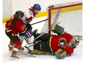 Calgary Inferno goalie, Lindsey Post stops Les Canadiennes De Montreal, Ann-Sophie Bettez in first period action at Winsport in Calgary, Alta., on Sunday, January 7, 2018. Darren Makowichuk/Postmedia