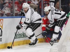 Los Angeles Kings defenseman Oscar Fantenberg (7) clears the puck after Los Angeles Kings left wing Alex Iafallo (19) checks Florida Panthers centre Aleksander Barkov (16) during the first period of an NHL hockey game, Saturday, Feb. 23, 2019, in Sunrise, Fla.