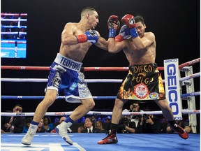 Teofimo Lopez, left, hits Diego Magdaleno during a lightweight boxing match Saturday, Feb. 2, 2019, in Frisco, Texas.