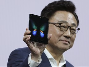 DJ Koh, President and CEO of IT and Mobile Communications, holds up the new Samsung Galaxy Fold smartphone during an event Wednesday, Feb. 20, 2019, in San Francisco.