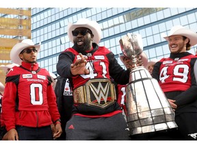 Calgary Stampeders defender Cordarro Law takes his turn with the Grey Cup as thousands of fans came out to the Nov. 27, 2018, victory celebration. Photo by Darren Makowichuk/Postmedia.