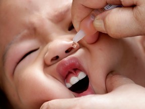 In this Friday, Sept. 12, 2014, file photo, a local health worker administers a vaccine to a baby at a local health centre at the financial district of Makati, east of Manila, Philippines.