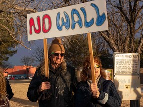People hold signs during a Presidents Day protest against Donald Trump's national emergency declaration in downtown Las Cruces, New Mexico, on February 18, 2019. (PAUL RATJE/AFP/Getty Images)