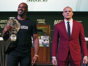 Jon Jones, left, and Anthony Smith pose for photographers during a news conference for the UFC 235 mixed martial arts event, Thursday, Jan. 31, 2019, in Las Vegas. The two are scheduled to fight March 2 in Las Vegas.