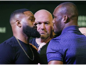Tyron Woodley, left, and Kamaru Usman pose for photographers during a news conference for the UFC 235 mixed martial arts event, Thursday, Jan. 31, 2019, in Las Vegas. The two are scheduled to fight March 2 in Las Vegas.