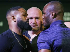 Tyron Woodley, left, and Kamaru Usman pose for photographers during a news conference for the UFC 235 mixed martial arts event, Thursday, Jan. 31, 2019, in Las Vegas. The two are scheduled to fight March 2 in Las Vegas.