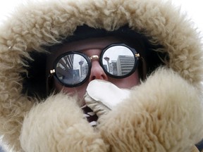 Jamie Tognazzini does her best to keep warm as the deep freeze hits Calgary on Sunday February 3, 2019. Darren Makowichuk/Postmedia