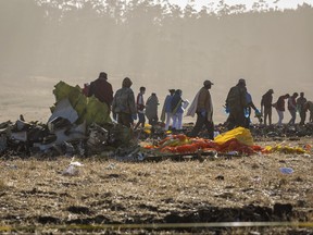 Rescuers work at the scene of an Ethiopian Airlines flight crash near Bishoftu, or Debre Zeit, south of Addis Ababa, Ethiopia, Monday, March 11, 2019. (AP Photo/Mulugeta Ayene)