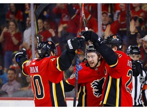 Calgary Flames Andrew Mangiapane, middle, celebrates his goal on Anaheim Ducks with teammates Derek Ryan, left and Garnet Hathaway, right, in NHL hockey action at the Scotiabank Saddledome in Calgary, Alta. on Friday February 22, 2019. Leah Hennel/Postmedia