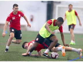 Cavalry FC Elijah Adekugbe competes for the ball with a defender in Calgary during day two of the Canadian Premier League team's inaugural training camp on Wednesday, March 6, 2019. Jim Wells/Postmedia