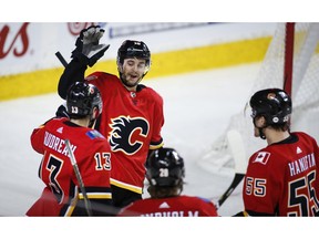 Calgary Flames' Derek Ryan, centre, celebrates his goal with teammates during third period NHL hockey action against the New Jersey Devils in Calgary, Tuesday, March 12, 2019.THE CANADIAN PRESS/Jeff McIntosh ORG XMIT: JMC114