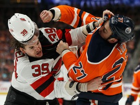 Edmonton Oilers' Milan Lucic fights New Jersey Devils' Kurtis Gabriel during the first period at Rogers Place in Edmonton, on Wednesday, March 13, 2019.