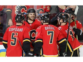 Calgary Flames forward Michael Frolik celebrates with teammates after scoring against the Columbus Blue Jackets in NHL hockey at the Scotiabank Saddledome in Calgary on Tuesday. Photo by Al Charest/Postmedia.