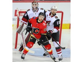 Calgary Flames Andrew Mangiapane battles against Oliver Ekman-Larsson in front of Cal Pickard of the Arizona Coyotes during NHL hockey at the Scotiabank Saddledome in Calgary on Monday, February 18, 2019. Al Charest/Postmedia