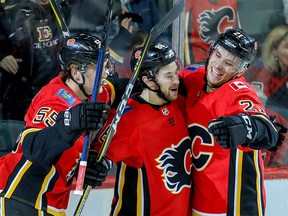 Calgary Flames Andrew Mangiapane (centre) celebrates after scoring against the Vegas Golden Knights at the Saddledome on Sunday.