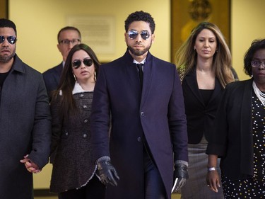 Actor Jussie Smollett, center, leaves the Leighton Criminal Courthouse in Chicago after prosecutors dropped all charges against him on Tuesday, March 26, 2019.