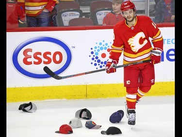 The Calgary Flames' Derek Ryan skates past hats after  it looked like a hat trick Sean Monahan might have a hat trick against the Anaheim Ducks' during third period NHL action in Calgary on Friday, March 29, 2019. Monahan ended up with the assist.  Ryan also scored in the third.