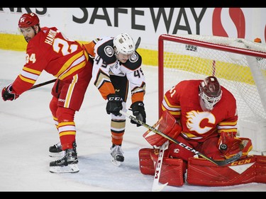 Calgary Flames goaltender Mike Smith and defenceman Travis Hamonic stops this scoring chance by the Anaheim Ducks' Max Jones during NHL action in Calgary on Friday, March 29, 2019.