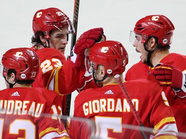 The Calgary Flames congratulate captain Mark Giordano after he scored on the Anaheim Ducks during NHL action in Calgary on Friday, March 29, 2019.