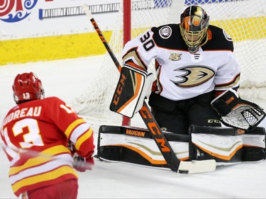 Calgary Flames forward Johnny Gaudreau gets a shot on the stick of Anaheim Ducks goaltender goalie Ryan Miller during NHL action in Calgary on Friday, March 29, 2019.