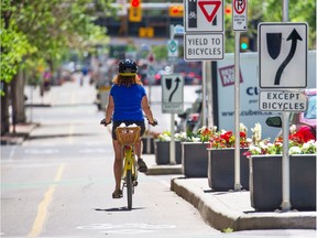 Cyclists ride on the 7th street S.W. bike lane in downtown Calgary on Wednesday June 27, 2018.