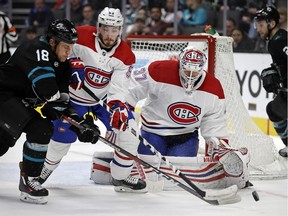 San Jose Sharks' Micheal Haley, left, takes a shot against Montreal Canadiens' Victor Mete (53) and goalie Antti Niemi (37) during the third period of an NHL hockey game Thursday, March 7, 2019, in San Jose, Calif.