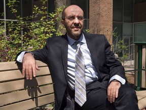 Belhassen Trabelsi sits outside the Immigration and Refugee Board offices, Tuesday, May 7, 2013, in Montreal.