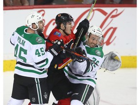 Stars Roman Polak (L) and Joel Hanley squeeze Flames Matthew Tkachuk in the crease during NHL action between the Dallas Stars and the Calgary Flames in Calgary on Wednesday, November 28, 2018. Dallas won in OT. Jim Wells/Postmedia