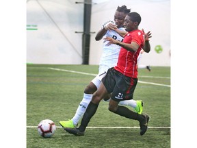 Whitecaps midfielder Georges Mukumbilwa (left) marks Cavalry FC Malyk Hamilton during an exhibition game between the Vancouver Whitecaps U23 and Cavalry FC at the Foothills Fieldhouse in Calgary on Tuesday. Hamilton scored one of the goals for Cavalry FC, who won 2-0. Photo by Jim Wells/Postmedia.