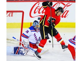 Calgary Flames Matthew Tkachuk attempts to redirect a puck past goalie Henrik Lundqvist of the New York Rangers during NHL hockey at the Scotiabank Saddledome in Calgary on Friday, March 2, 2018.