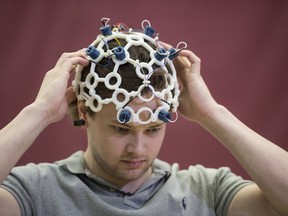 Stephen Doyle, wearing a neuro cap spent countless hours working on a research project using brain waves to fly a drone on March 19, 2019 at MacEwan University.