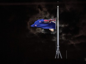 The New Zealand national flag is flown at half-mast on a Parliament building in Wellington on March 15, 2019, after 49 people died in attacks on two mosques in Christchurch.