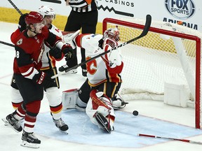 Calgary Flames goaltender Mike Smith gives up a goal to Arizona Coyotes' Jakob Chychrun in the third period on Thursday, March 7, 2019, in Glendale, Ariz.