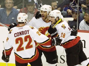 Jarome Iginla celebrates with Craig Conroy and Matthew Lombardi after scoring against the Vancouver Canucks during Game 7 of the first round of the 2004 playoffs.