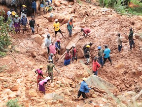 A family dig for their son who got buried in the mud when Cyclone Idai struck in Chimanimani about 600 kilometres south east of Harare, Zimbabwe, Tuesday, March, 19, 2019.
