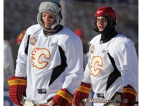Calgary Flames D Robyn Regehr (left), wearing a Saskatchewan hat, skates with teammate Mark Giordano during Flames practice at McMahon Stadium prior to the Heritage Classic in Calgary on Feb. 19, 2011. Postmedia file photo.