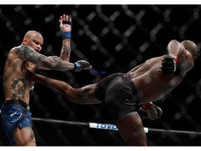 Jon Jones (R) lands a kick on Anthony Smith during a light heavyweight title bout during UFC 235 at T-Mobile Arena on March 2, 2019 in Las Vegas.