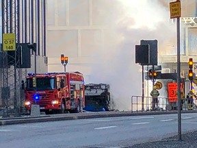 An emergency vehicle stands in front of the bus that exploded and caught fire in central Stockholm, Sweden on Sunday March 10, 2019.
