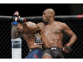 Jon Jones, right, fights Anthony Smith in a light heavyweight mixed martial arts title bout at UFC 235, Saturday, March 2, 2019, in Las Vegas.